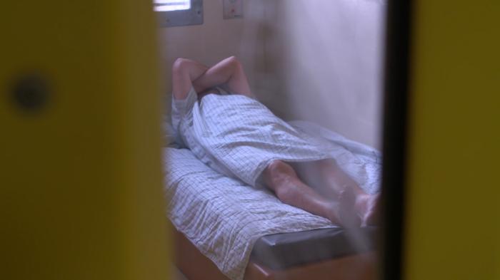 Prisoner lying on bed